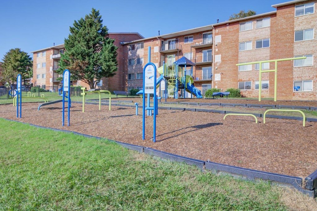 a playground in front of an apartment building