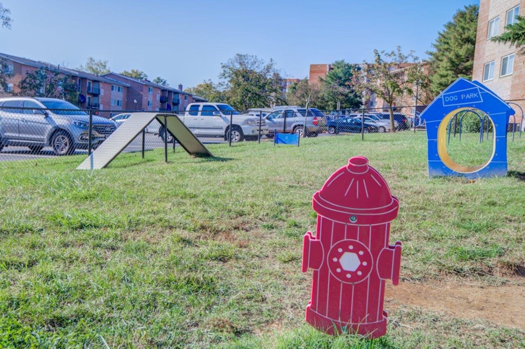 a red fire hydrant sitting in the middle of a field