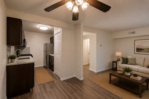 A living room with a brown coffee table and a white couch.