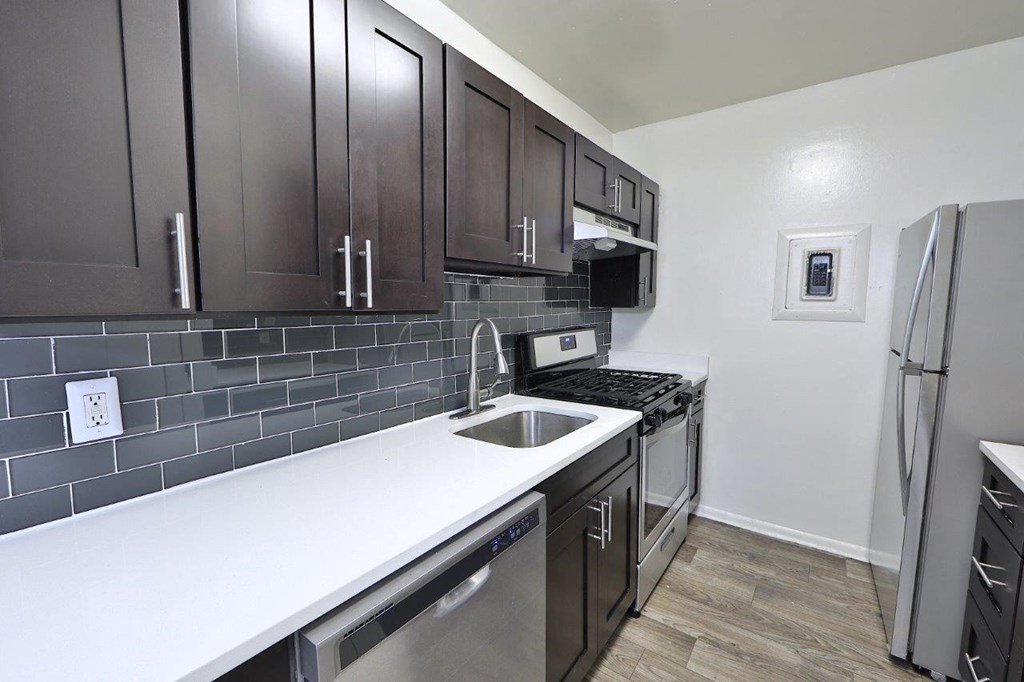 a kitchen with stainless steel appliances and wooden cabinets