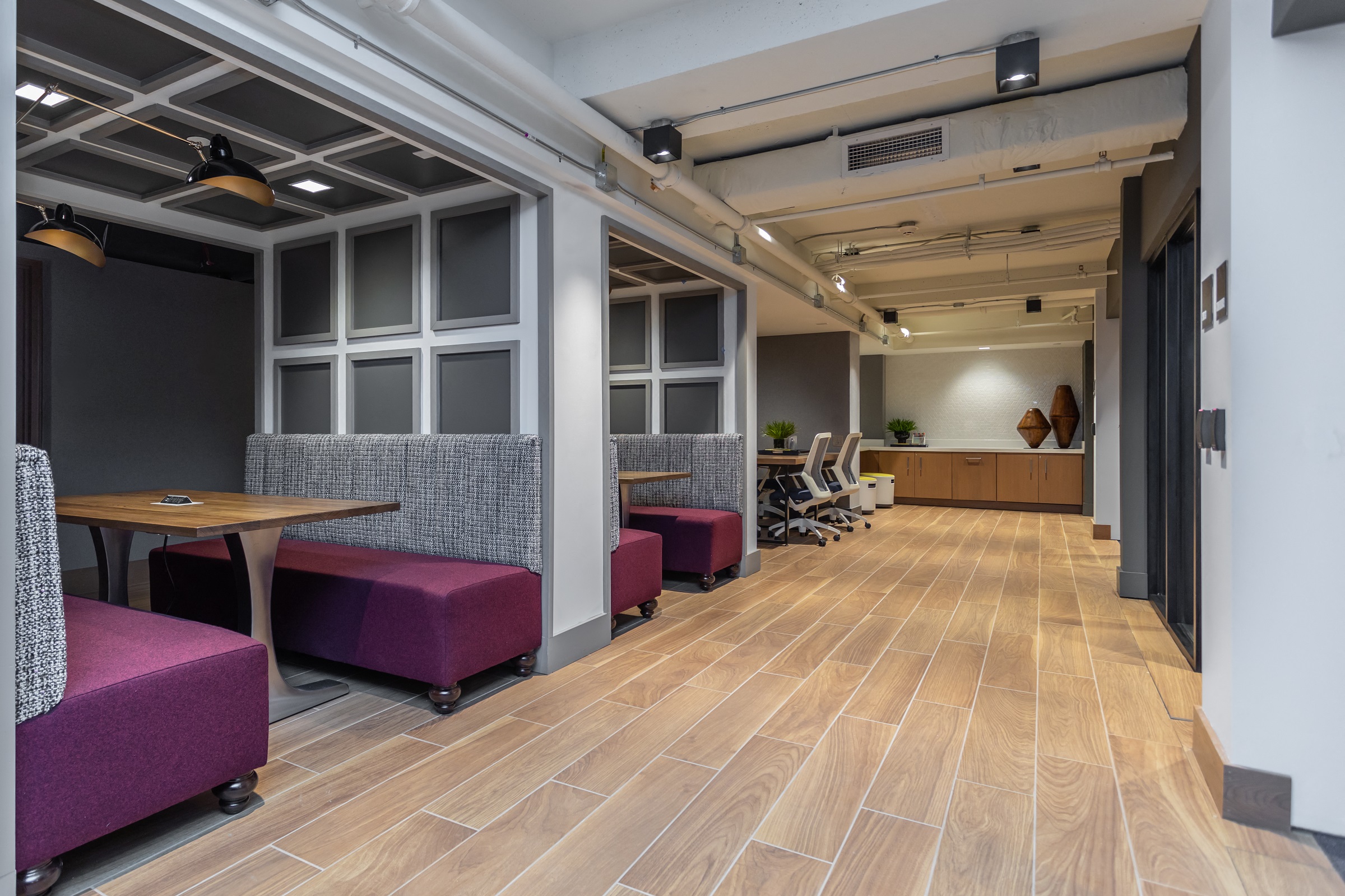 a large room with tables and chairs and a wood floor
