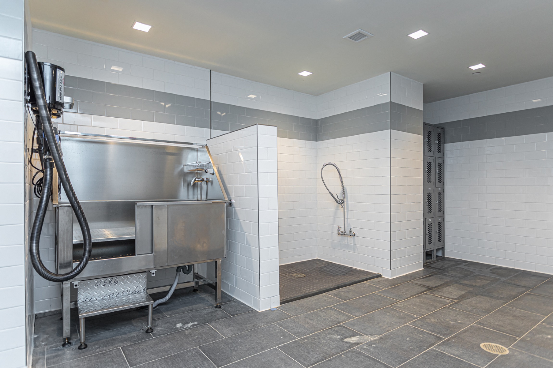 a large stainless steel boiler in a bathroom with a stainless steel sink