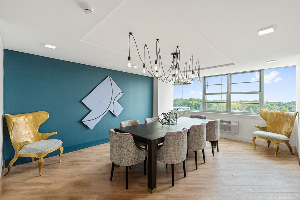 The dark wood dining table in the clubhouse at The Dane in Wynnefield, PA