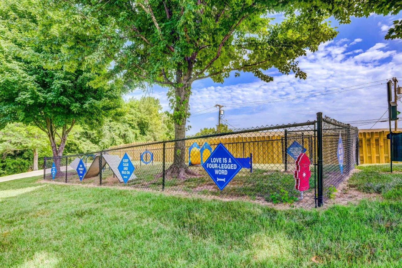 a chain link fence with blue and white signs on it