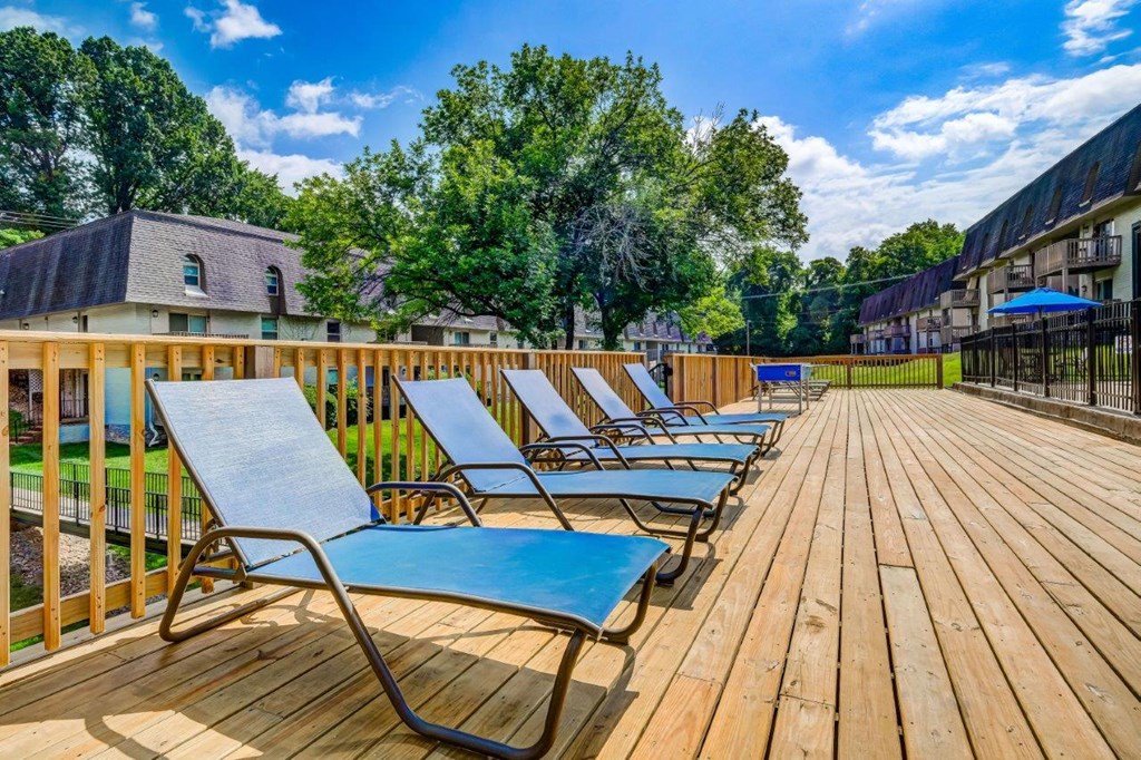 the deck has a bunch of lounge chairs on it