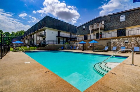a swimming pool with a building in the background