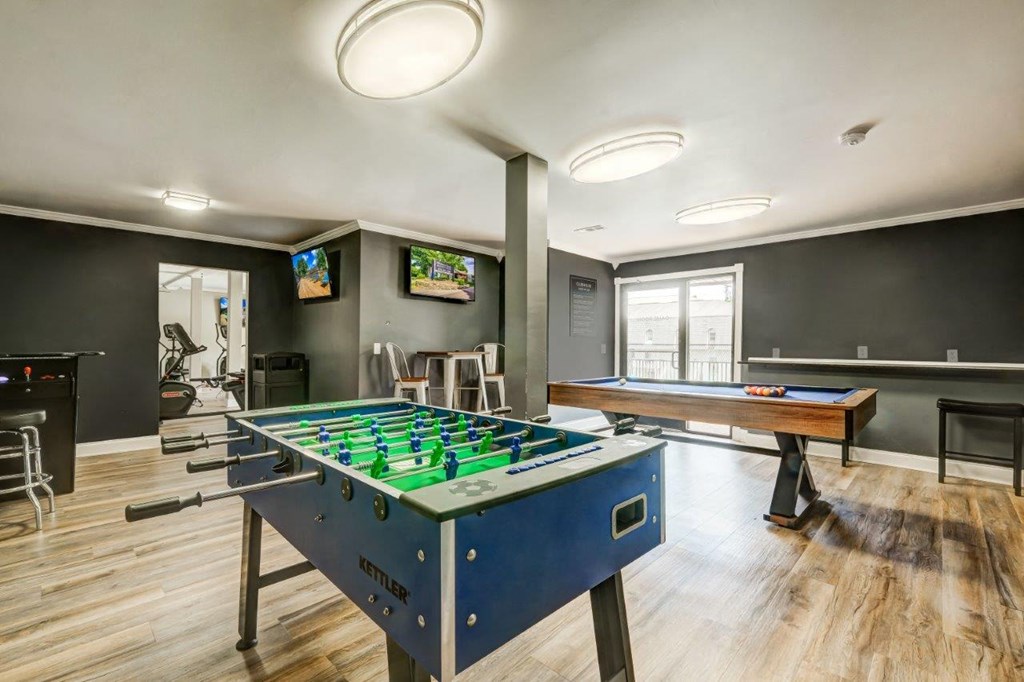 a game room with a foosball table and a pool table