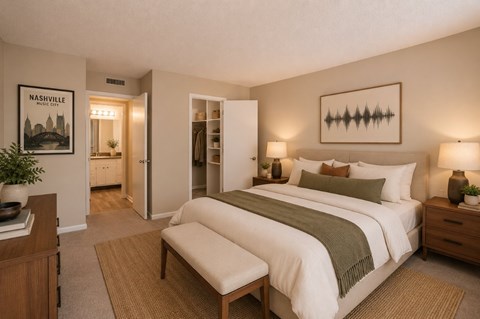 A bedroom with a bed, nightstand, and a poster on the wall.