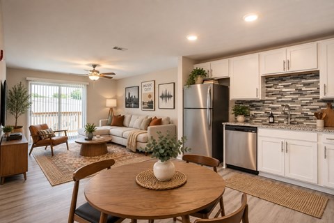 A modern kitchen with a dining table and chairs.