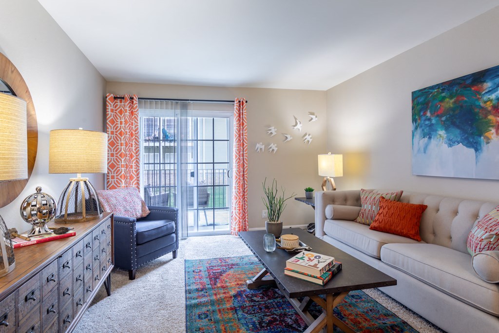 a living room with a couch and a coffee table and a balcony