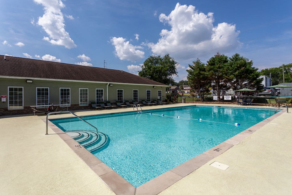 a swimming pool with a building in the background