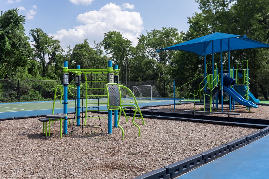 a playground with a swing set and a basketball court