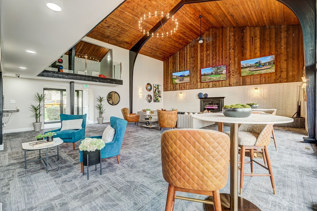 a living room with chairs and a table and a fireplace