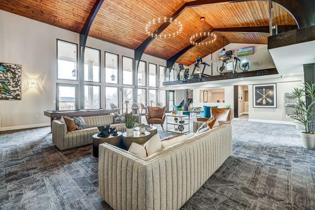 a living room with couches and chairs and a fireplace