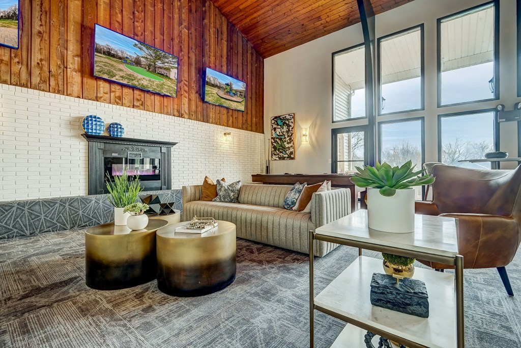 a living room with a couch and a table and a fireplace