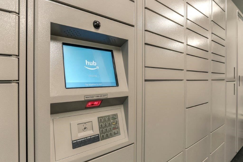 an atm machine in a hallway with white cabinets