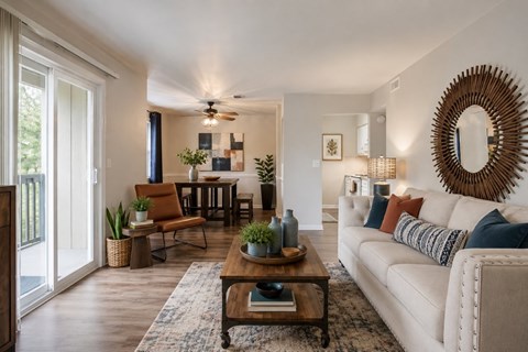 A living room with a white couch and a wooden coffee table.