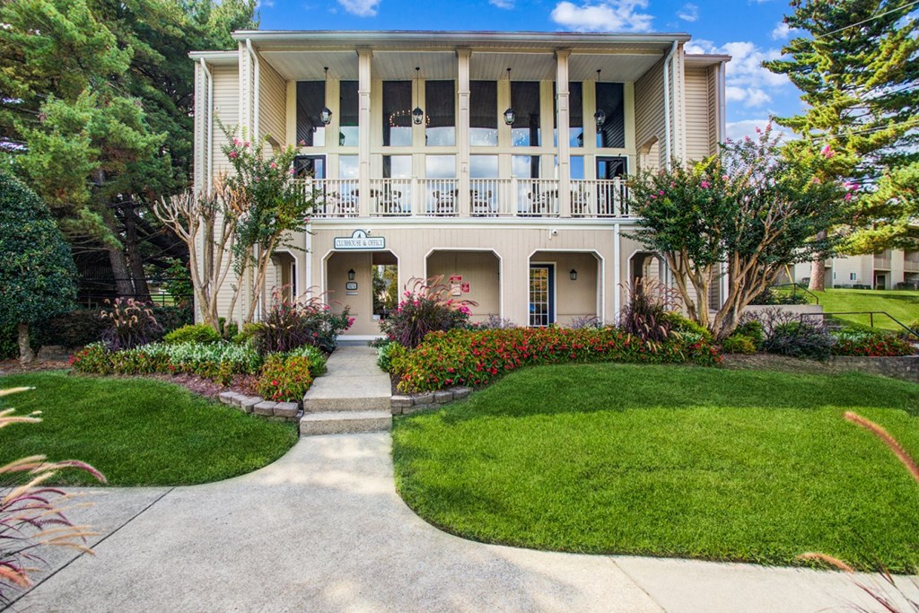 a house with a walkway and lawn in front of it