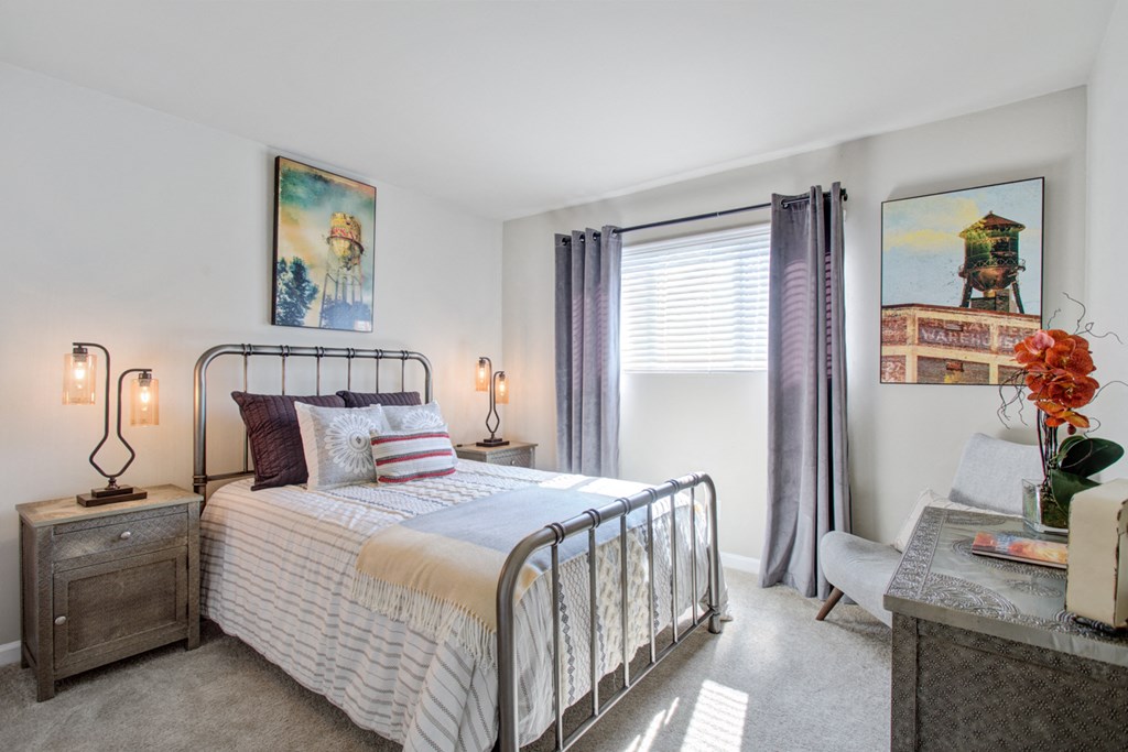 a bedroom with a bed and a window with purple curtains