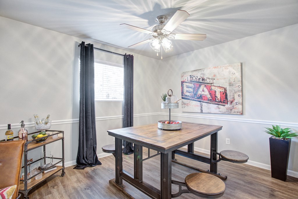 a dining room with a table and a ceiling fan