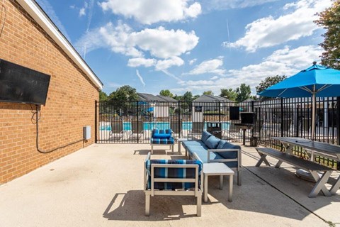 our apartments have a large patio with furniture and a pool