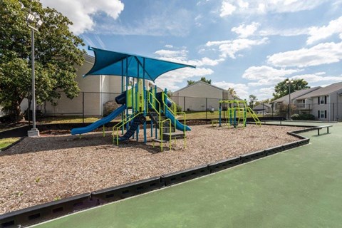 a playground with a blue and yellow swing set
