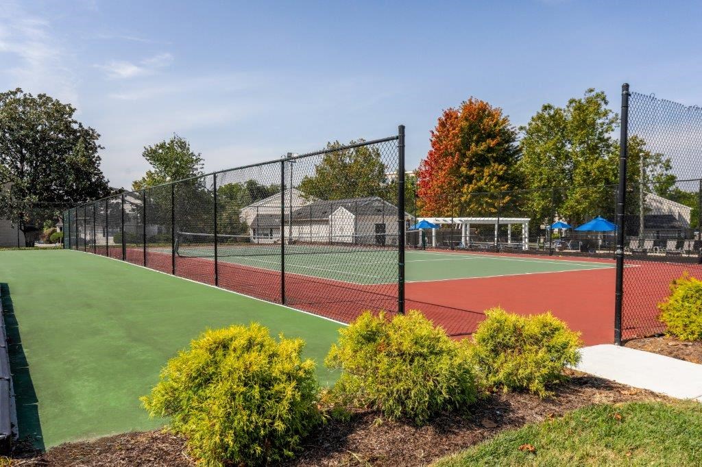 a tennis court with a chain link fence around it