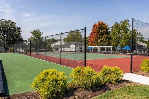 a tennis court with a chain link fence around it