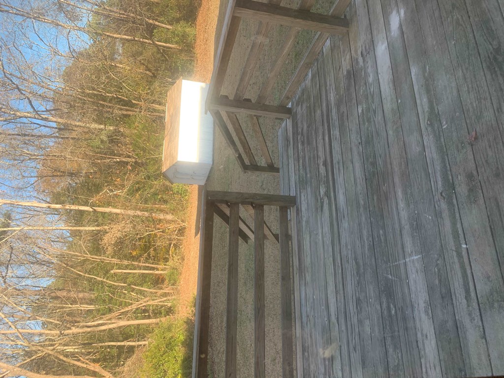 a light on the side of a building in the woods