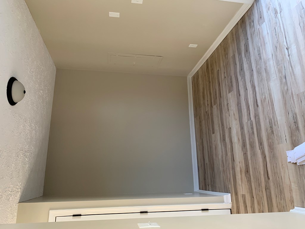 a view down a staircase with a wood wall behind it