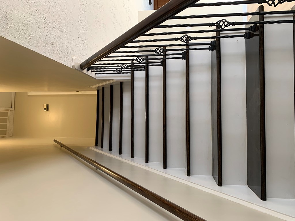 a row of prison cells in a white room