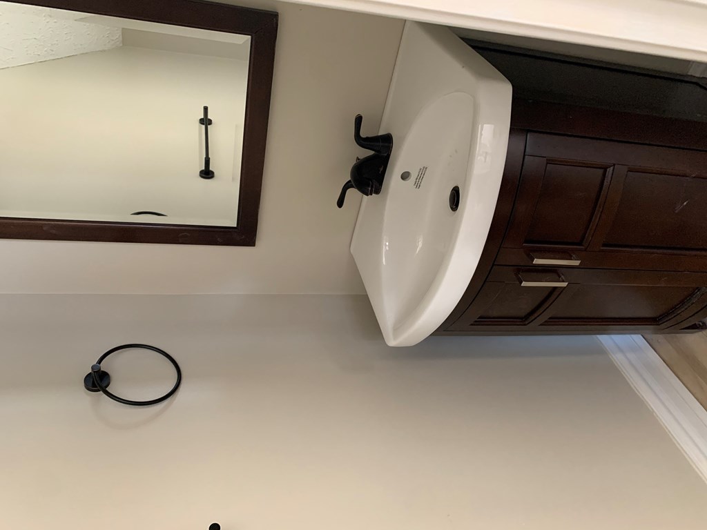 a large white sink in a bathroom with a mirror