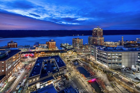 a city at night with the lake in the background