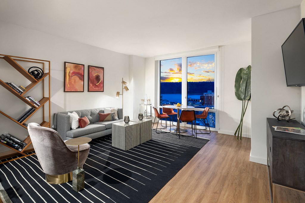 a living room with a couch and a table and a large window