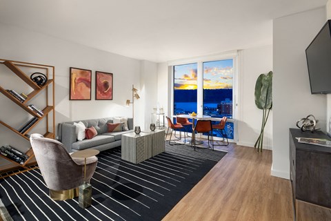 a living room with a couch and a table and a large window