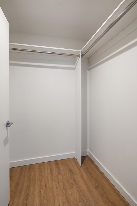 an empty room with white walls and wooden floors