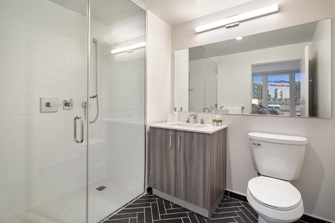 a bathroom with a toilet sink and shower