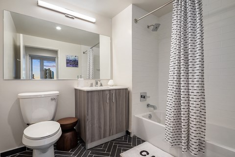 a bathroom with a toilet and a shower and a sink