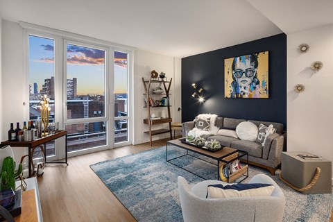 a living room with a couch and a chair and a window