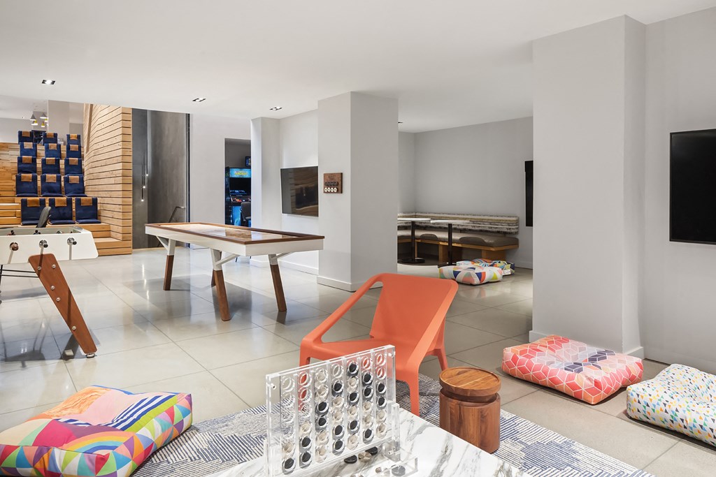 a living room with a table and chairs and a television