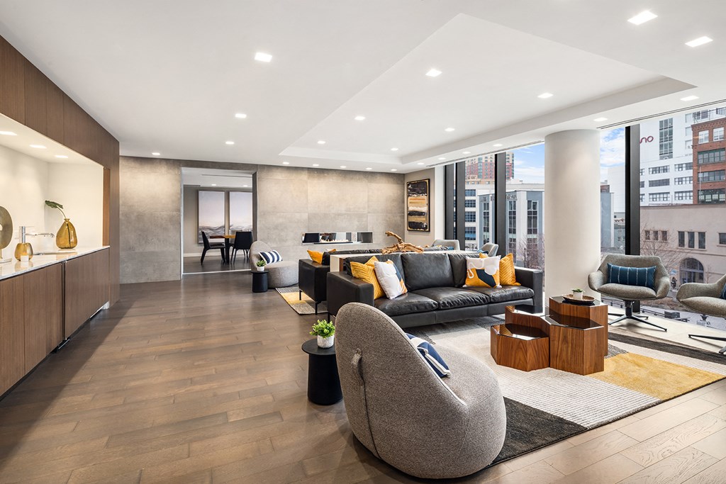 a living room with couches and chairs and a large window