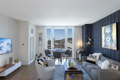 a living room with a couch and a table with chairs