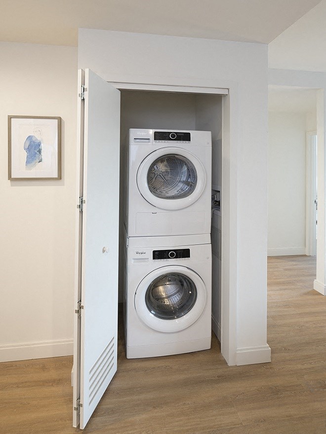 a front loading washer and dryer in a walk in laundry room