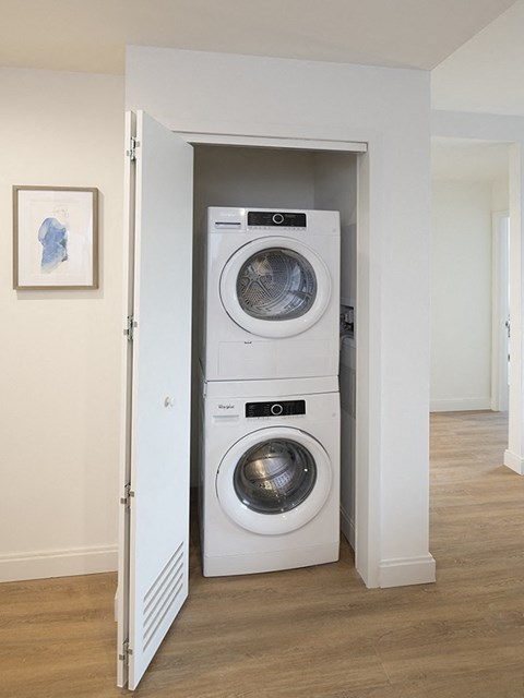 a front loading washer and dryer in a walk in laundry room
