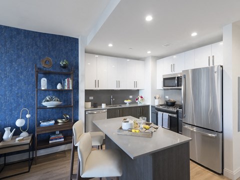 a kitchen with stainless steel appliances and a marble counter top
