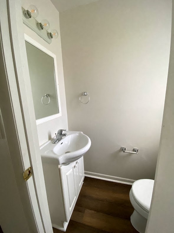 Westfalen Apartments - Half-bath in Hallway off living room / Sink with cabinet / mirror / wood-grain, vinyl plank flooring