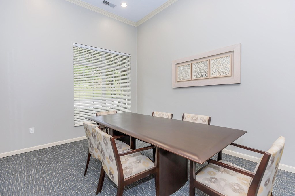 a dining room table with chairs and a window