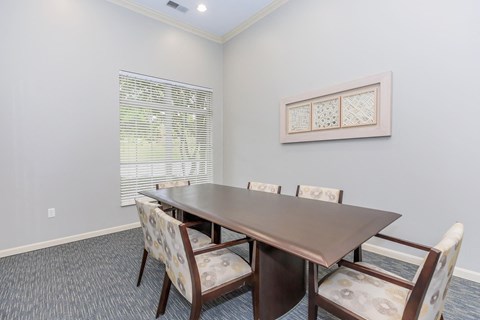 a dining room table with chairs and a window