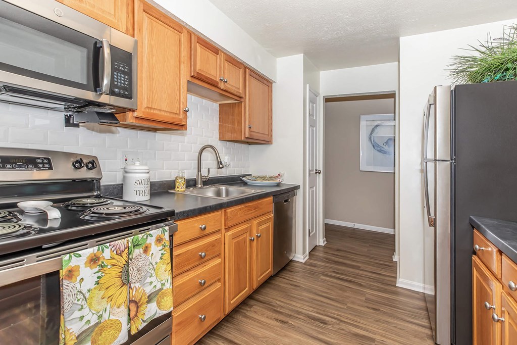 a kitchen with stainless steel appliances and wooden cabinets
