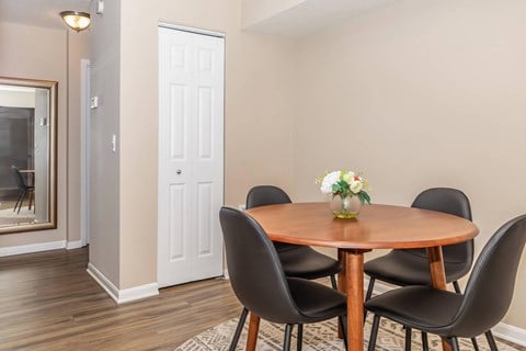 a dining room with a wooden table and chairs